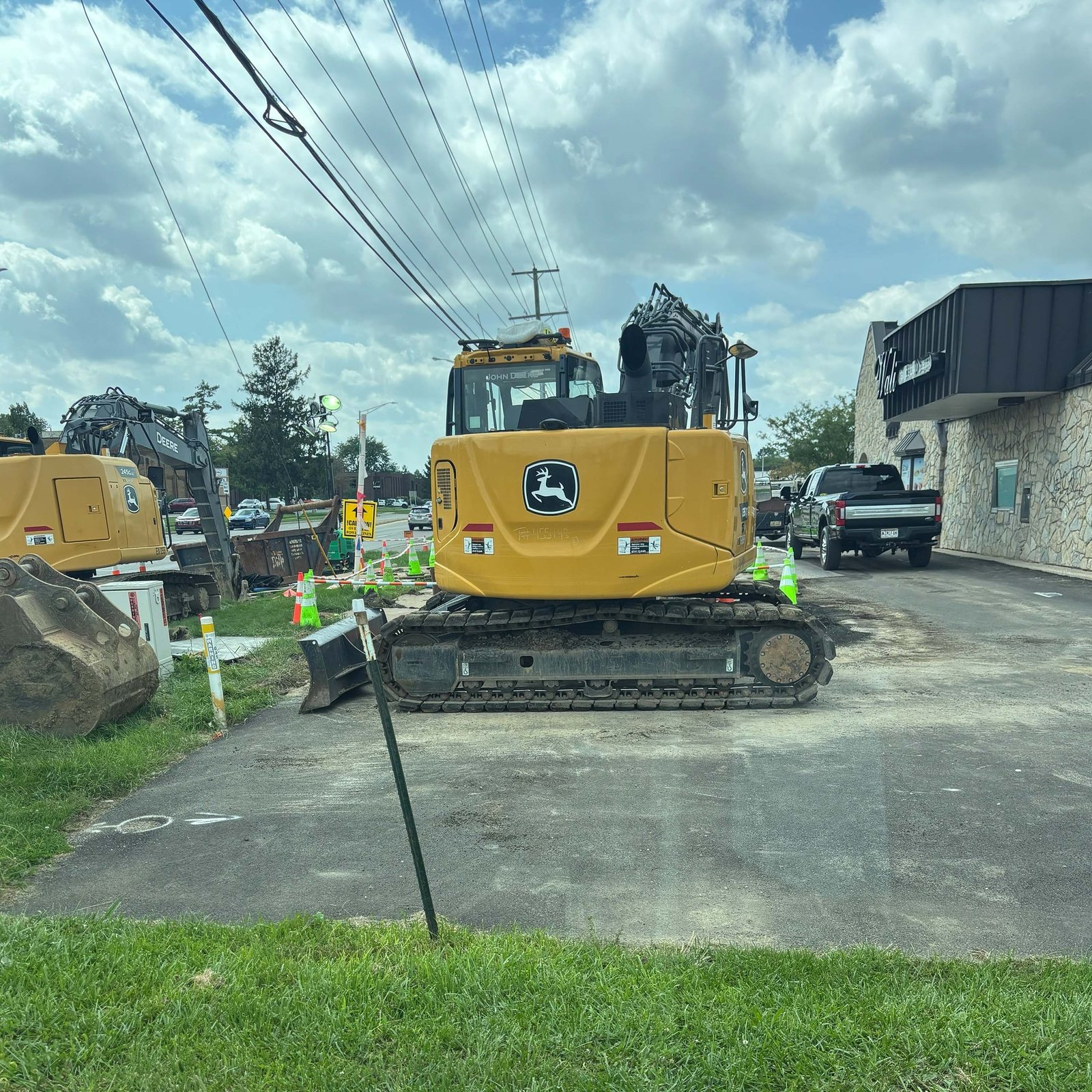Excavator resting where the old pavement came out