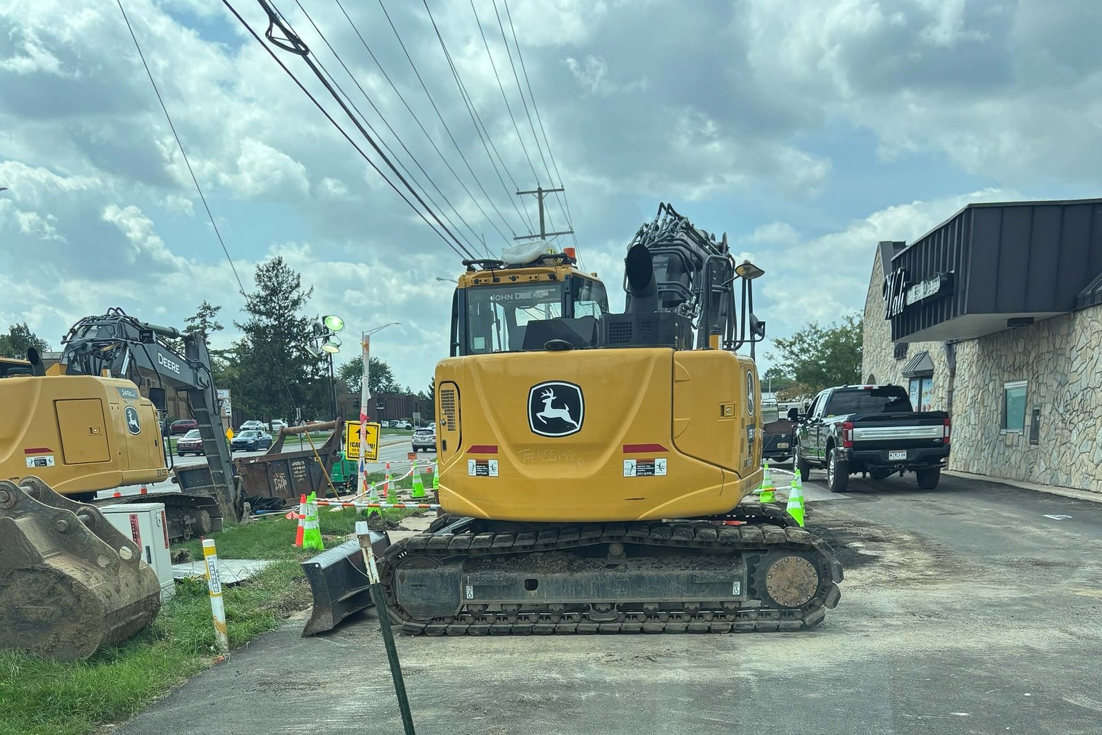 Excavator parked on a pad where old pavement was removed