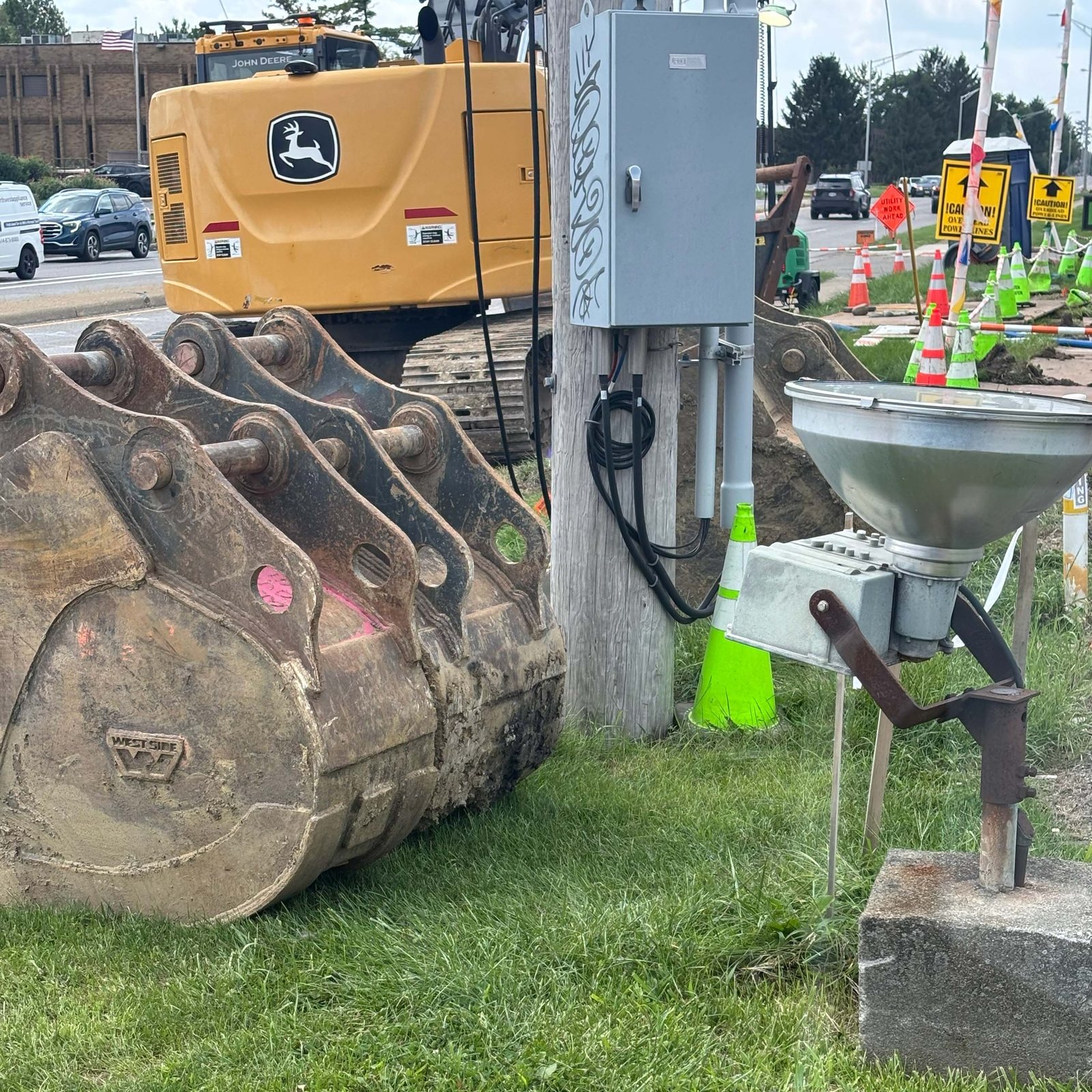 Excavator buckets in a row at the utility project