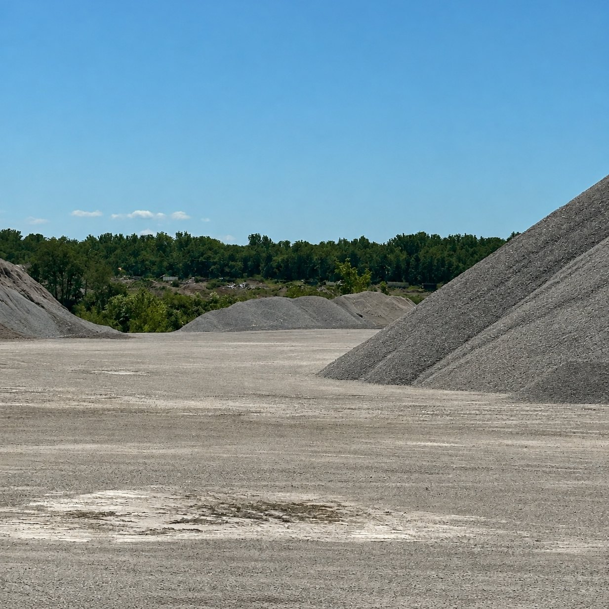 Screened stone piles lined up in the quarry yard