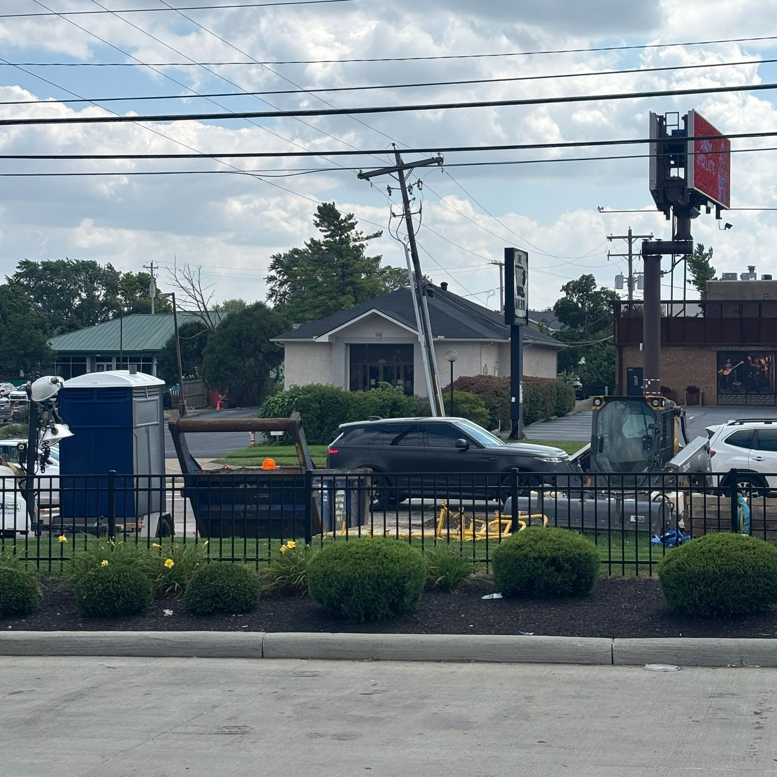 Fenced work zone on a commercial street corner
