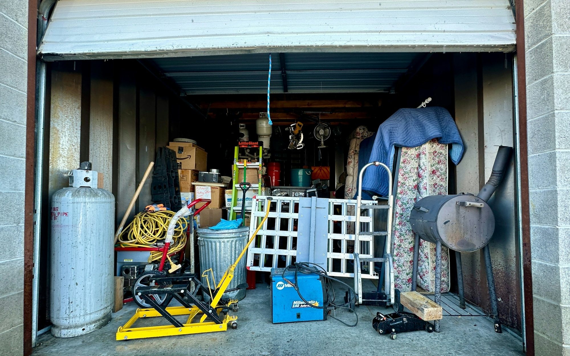 A garage packed wall to wall with stored belongings
